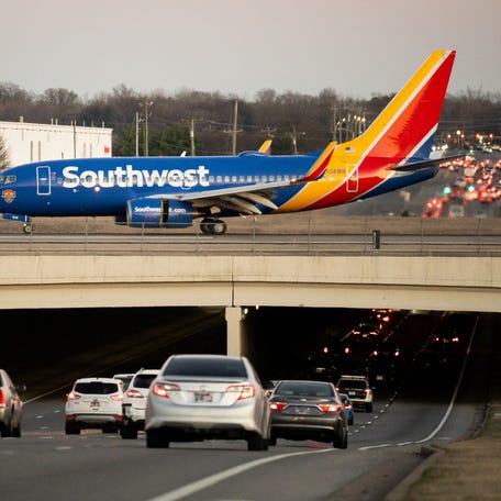 A Southwest Airlines flight taxis over Murfreesboro Pike after arriving at Nashville International Airport in Nashville, Tenn., Thursday, Jan. 15, 2026.