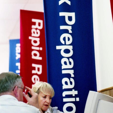 Judy Stephenson, right, a tax preparer for H&R Block, assists Larry Crissup of Nashville with his income tax return.