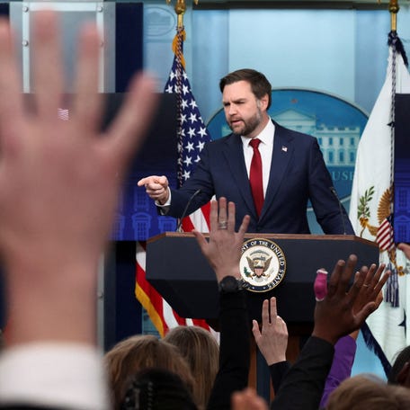 FILE PHOTO: Hands are risen as U.S. Vice President JD Vance speaks to reporters in the briefing room at the White House in Washington, D.C., U.S., January 8, 2026. REUTERS/Kevin Lamarque/File Photo