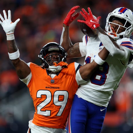 Ja'Quan McMillian #29 of the Denver Broncos intercepts a pass intended for Brandin Cooks #18 of the Buffalo Bills during overtime in the AFC Divisional Playoff game at Empower Field At Mile High on January 17, 2026 in Denver, Colorado.