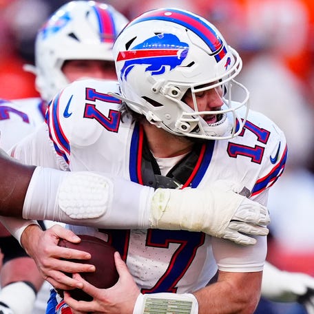 Jan 17, 2026; Denver, CO, USA; Denver Broncos defensive tackle Malcolm Roach (97) tackles Buffalo Bills quarterback Josh Allen (17) during the second quarter of an AFC Divisional Round playoff game at Empower Field at Mile High. Mandatory Credit: Ron Chenoy-Imagn Images