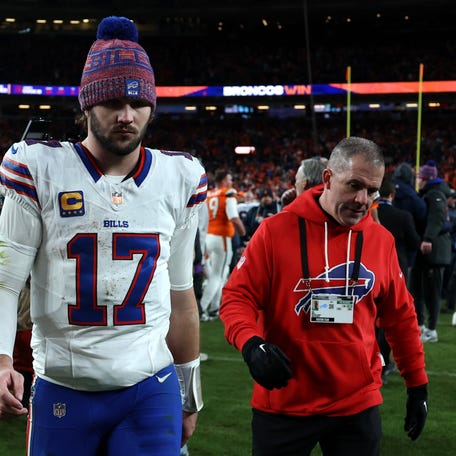 DENVER, COLORADO - JANUARY 17: Josh Allen #17 of the Buffalo Bills walks off the field after being defeated by the Denver Broncos with a score of 30 to 33 in overtime of the AFC Divisional Playoff game.