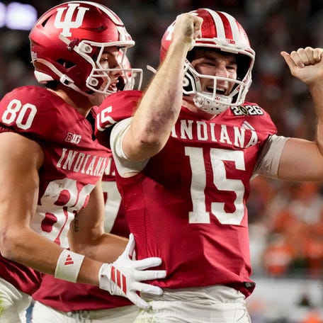Indiana Hoosiers quarterback Fernando Mendoza (15) celebrates with his teammates after rushing for a touchdown Monday, Jan. 19, 2026, during the College Football Playoff National Championship college football game at Hard Rock Stadium in Miami Gardens.