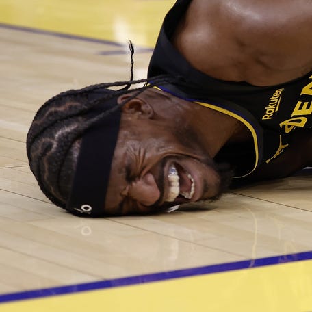 Golden State Warriors forward Jimmy Butler III (10) holds his right knee as he goes down with an injury during the third quarter against the Miami Heat at Chase Center in San Francisco, California on Jan. 19, 2026.