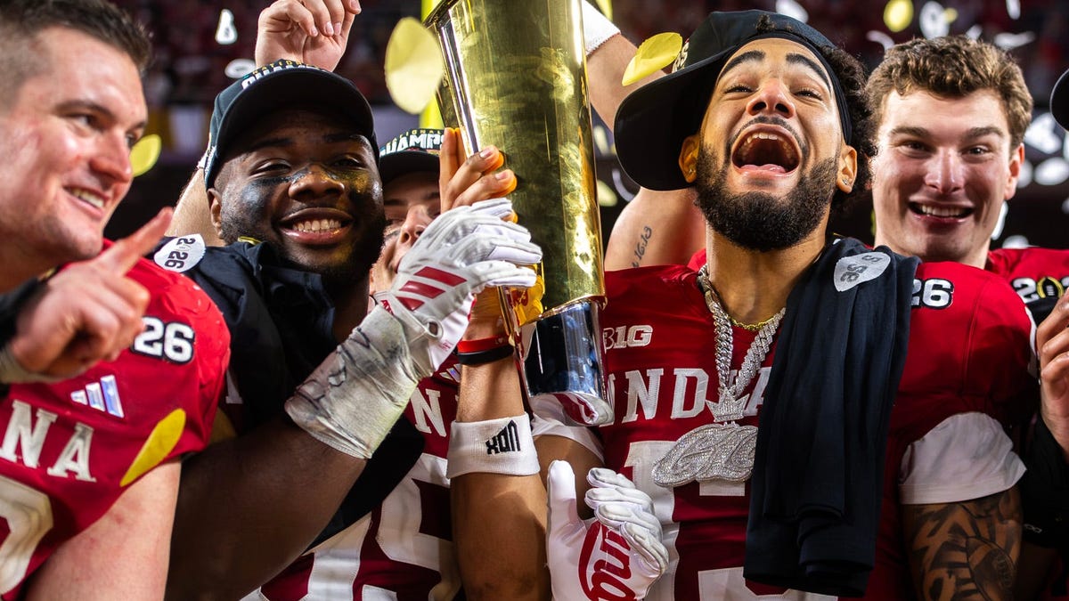 Indiana's Elijah Sarratt (13), and Tyrique Tucker (95) celebrated with teammates after defeating Miami in the College Football Playoff national championship game at Hard Rock Stadium in Miami Gardens, Fla., on Jan. 19, 2026.