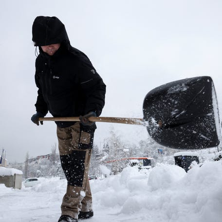 A worker shovels snow in Sarajevo, Bosnia and Herzegovina on Jan. 8, 2026.