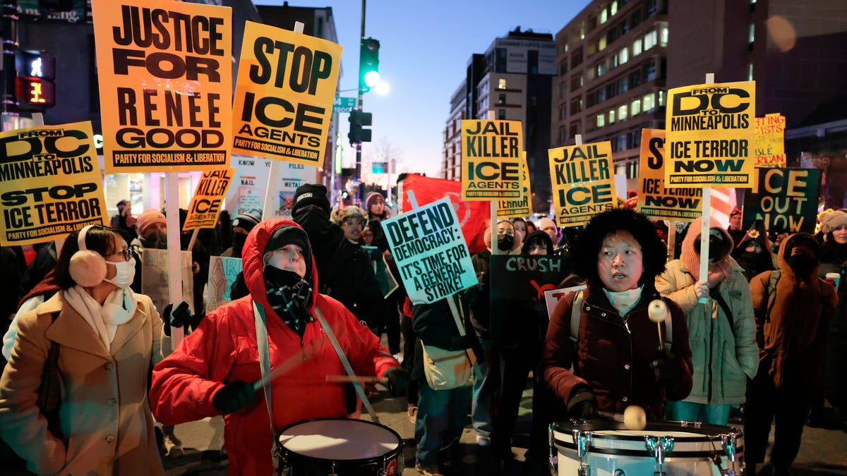 Activists hold signs reading "Justice For Renee Good" as they demonstrate against ICE during a protest on the one-year anniversary of President Trump's inauguration on Jan. 20, 2026 in Washington, DC. Protestors gathered to call for Immigration and Customs Enforcement (ICE) to leave Washington, D.C.