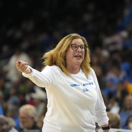 UCLA coach Cori Close talks with guard Kiki Rice.