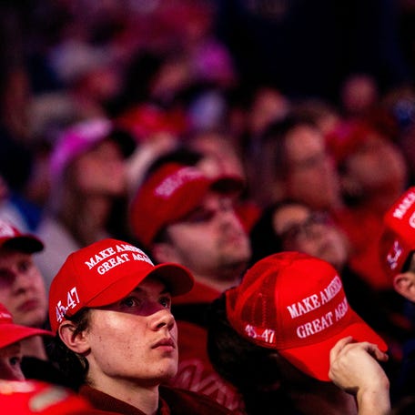 Attendees wearing 'MAGA' caps wait ahead of a campaign rally featuring then-Republican presidential nominee Donald Trump in Grand Rapids, Michigan, U.S., November 4, 2024.