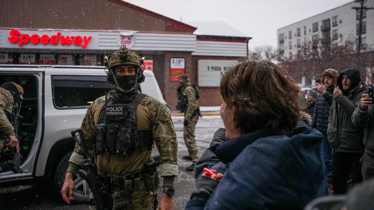 People confront U.S. Border Patrol agents of commander Greg Bovino's team at a speedway gas station in Minneapolis, Minnesota, U.S., Jan. 21, 2026.