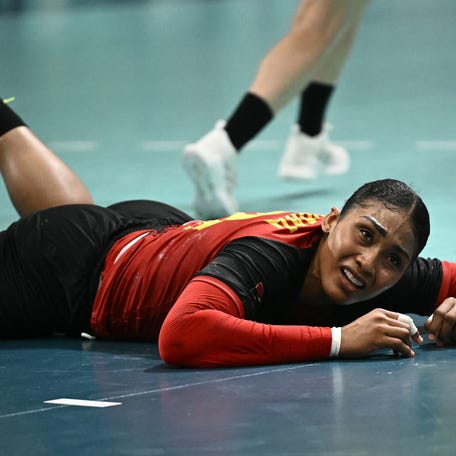 Angola's pivot #10 Albertina Kassoma reacts as she lies on the floor during the Women's Preliminary Round Group B handball match between Brazil and Angola of the Paris 2024 Olympic Games, at the Paris South Arena in Paris, on August 3, 2024. (Photo by Aris MESSINIS / AFP) (Photo by ARIS MESSINIS/AFP via Getty Images)