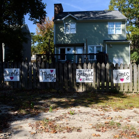 Signs with the names of victims are seen on a fence in the Hedingham neighborhood on Oct. 15, 2022, in Raleigh, North Carolina. (Photo by Melissa Sue Gerrits/Getty Images)