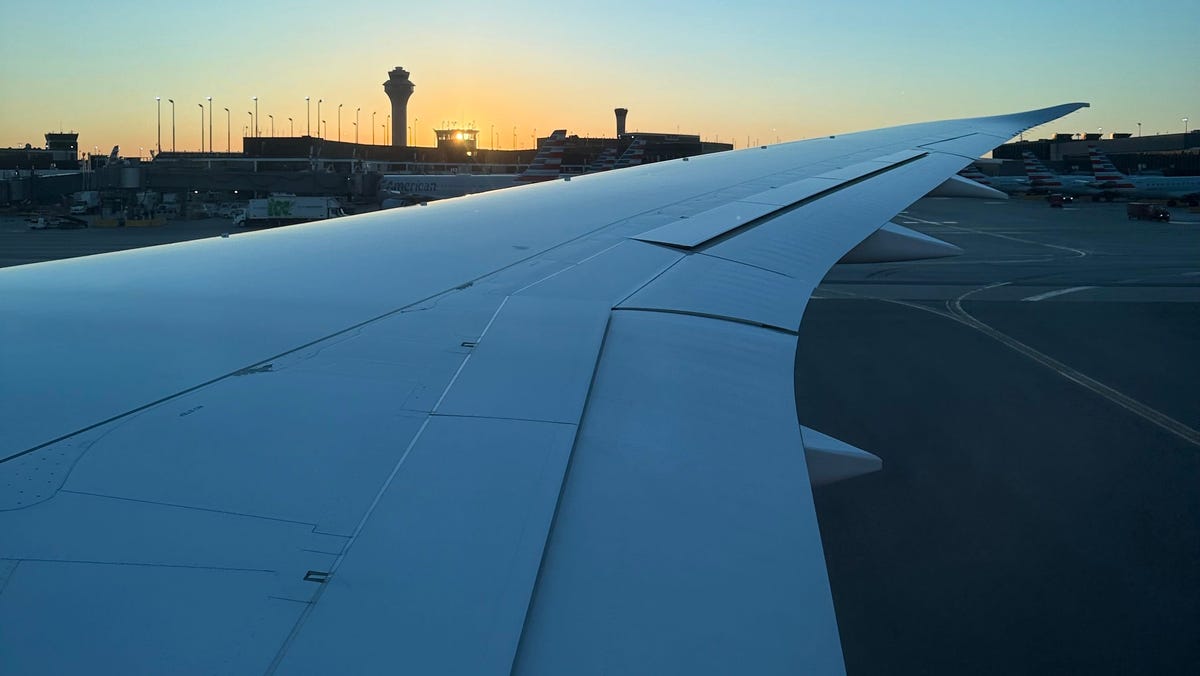 A watch tower stands in the distance of an American Airlines aircraft wing at Chicago's O'Hare International Airport on Oct. 8, 2025.