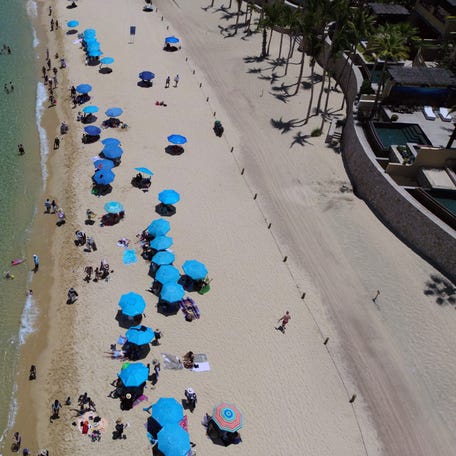 An aerial view of tourists enjoying the beach at a resort in Los Cabos, Baja California, Mexico on July 15, 2025.