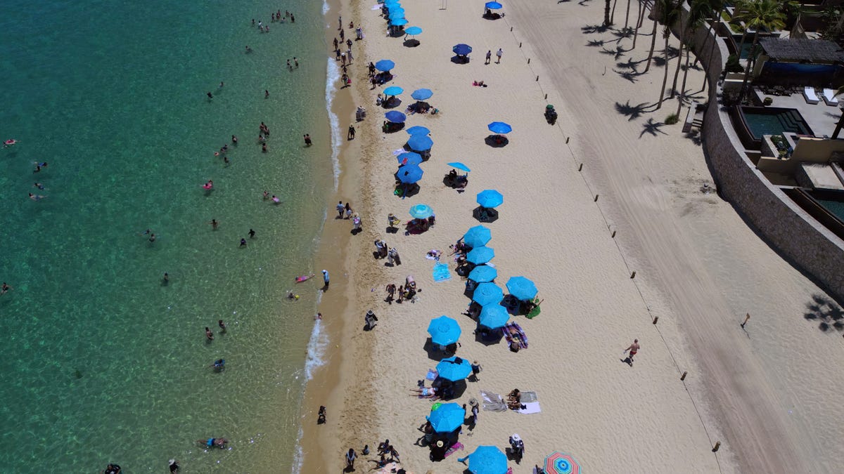 An aerial view of tourists enjoying the beach at a resort in Los Cabos, Baja California, Mexico on July 15, 2025.