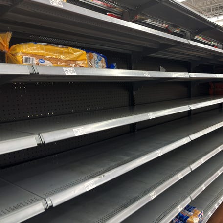 Aisles and shelves sit empty as people stock up on grocery items in preparation for a winter storm on Wednesday, Jan. 21, 2025, at Walmart Neighborhood Market in Oklahoma.