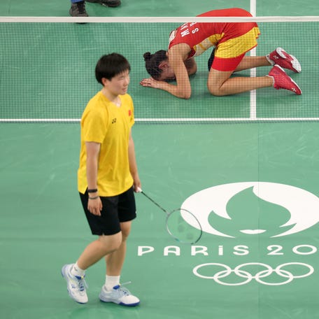 PARIS, FRANCE - AUGUST 04: Carolina Marin of Team Spain reacts after appearing to suffer an injury during the Women's Singles Semifinal match against Bing Jiao He of Team People's Republic of China on day nine of the Olympic Games Paris 2024 at Porte de La Chapelle Arena on August 04, 2024 in Paris, France. (Photo by Michael Reaves/Getty Images)