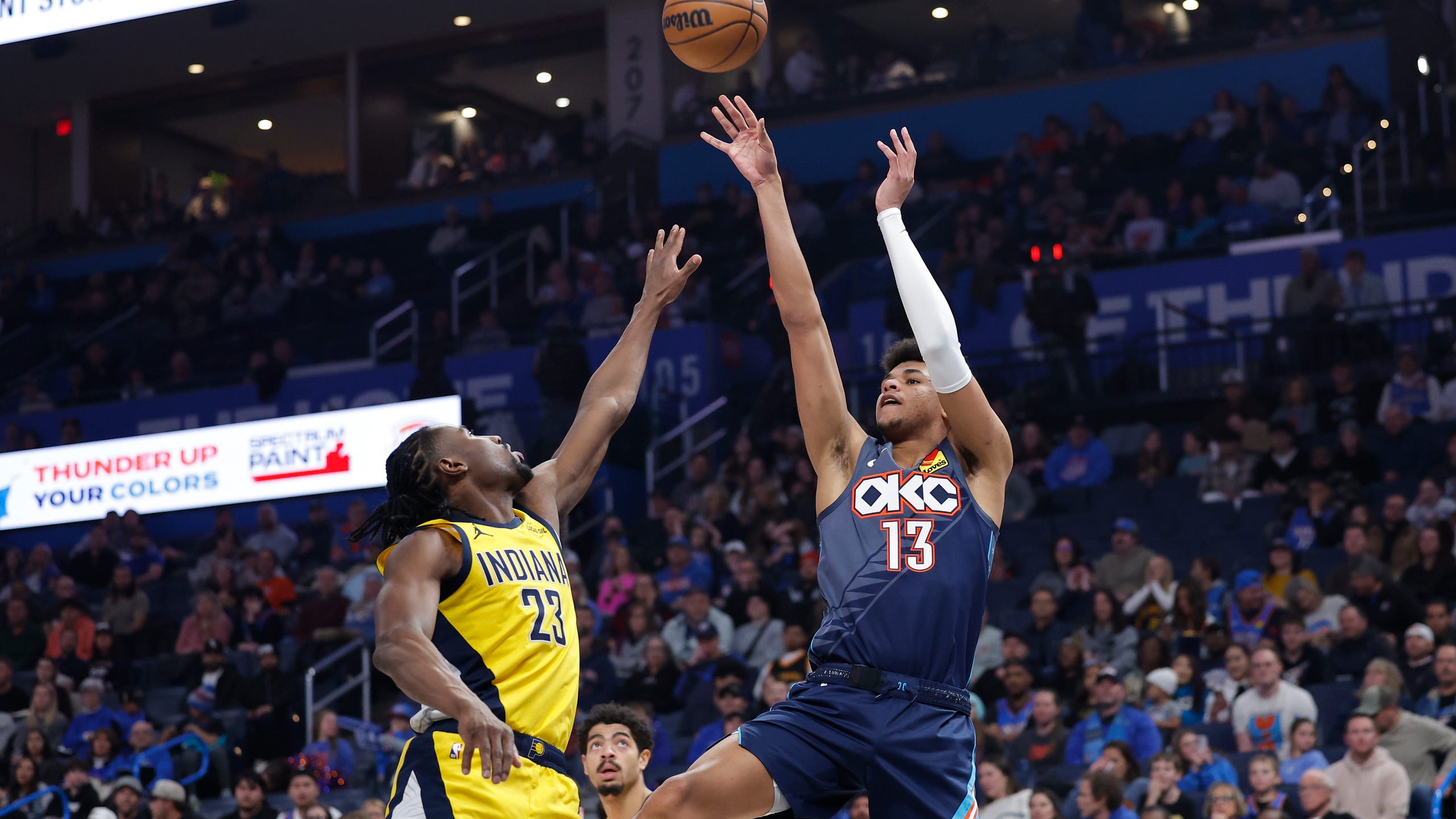 Jan 23, 2026; Oklahoma City, Oklahoma, USA; Oklahoma City Thunder forward Ousmane Dieng (13) shoots as Indiana Pacers guard/forward Aaron Nesmith (23) defends during the second quarter at Paycom Center. Mandatory Credit: Alonzo Adams-Imagn Images  