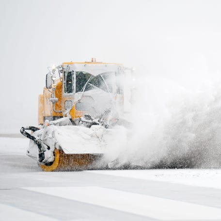 Snow plows clear a runway at Nashville International Airport in Nashville, Tenn., Saturday, Jan. 24, 2026. A winter storm brought snow and ice to Middle Tennessee on Saturday.