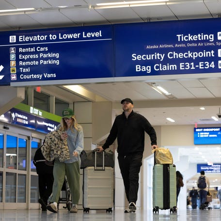 Travelers enter the terminal at the Dallas Fort Worth International Airport in Fort Worth, Texas on January 23, 2026.