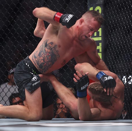 Justin Gaethje punches Paddy Pimblett during their interim lightweight title bout.