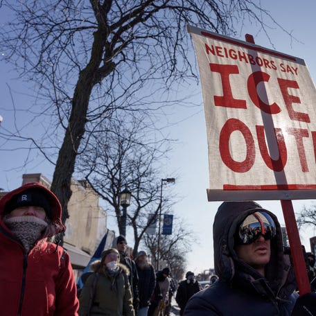 Demonstrators carry signs condemning Immigration and Customs Enforcement (ICE) near the site where a man identified as Alex Pretti was fatally shot by federal agents trying to detain him, in Minneapolis, Minnesota, U.S., January 24, 2026.