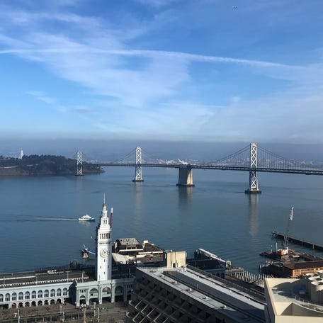 The San Francisco-Oakland Bay Bridge is seen behind the Embarcadero in San Francisco.