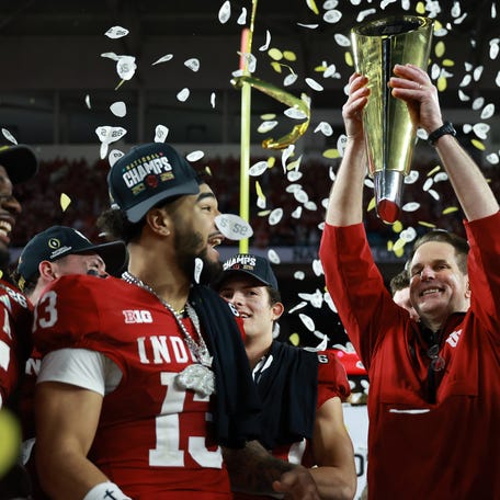 Jan 19, 2026; Miami Gardens, FL, USA; Indiana Hoosiers head coach Curt Cignetti hoists the National Championship trophy in the air after the College Football Playoff National Championship game at Hard Rock Stadium. Mandatory Credit: Mark J. Rebilas-Imagn Images