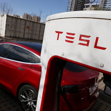 A Tesla car charges at a Supercharger charging station of the electric vehicle maker in Beijing, China March 24, 2025.