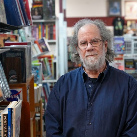 Greg Ketter, owner of Dream Haven Books & Comics in Minneapolis, poses for a photo inside his bookstore after a photo and video of him walking through tear gas went viral following the Jan. 24, 2026, fatal shooting of Alex Pretti by federal immigration enforcers.