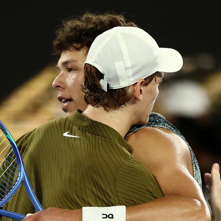 Jannik Sinner hugs Ben Shelton after winning their quarterfinal match at the Australian Open.