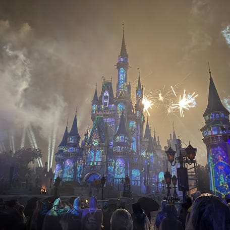 Poncho-clad guests stand in the rain to watch fireworks during Mickey's Not-So-Scary Halloween Party at Magic Kingdom on Oct. 9, 2025. While ponchos are sold across Walt Disney World, much of the year, guests should pack light ponchos for Florida's fickle weather.