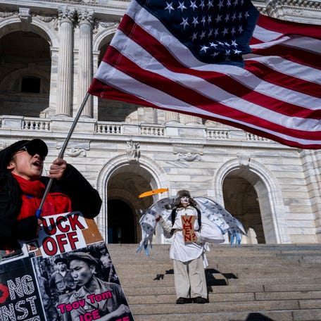 Anti ICE protesters stand outside the Minnesota State Capitol Building after a small group of demonstrators gathered outside the office of the Minnesota Governor in Minneapolis, Minnesota, on January 27, 2026. On January 24, federal agents shot and killed Alex Pretti, a 37-year-old ICU nurse, while scuffling with him on an icy roadway in Minneapolis, less than three weeks after an immigration officer fired on Renee Good, also 37, killing her in her car. The fatal shootings has reignited   accusations that federal agents enforcing US President Donald Trump's militarized immigration crackdown are inexperienced, under-trained and operating outside law enforcement norms. (Photo by ROBERTO SCHMIDT / AFP via Getty Images)