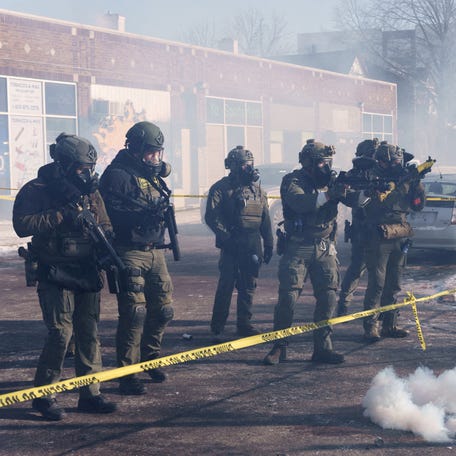 Federal officers fire munitions toward demonstrators near the site where Alex Pretti was fatally shot by border agents in Minneapolis on Jan. 24, 2026.