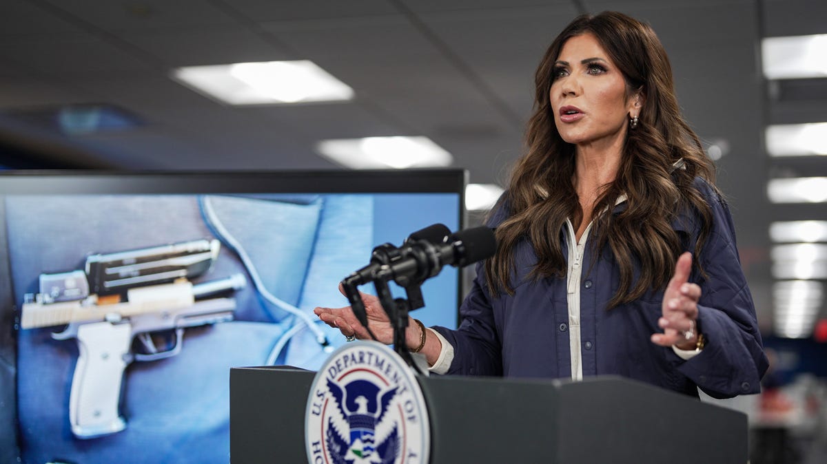 A photograph of the pistol recovered by immigration agents after a shooting in Minneapolis, Minnesota on Saturday morning is shown on a screen behind U.S. Secretary of Homeland Security Kristi Noem as she speaks during a news conference in the National Response Coordination Center at the Federal Emergency Management Agency (FEMA) headquarters on January 24, 2026 in Washington, DC.