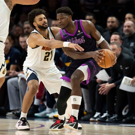 Minnesota Timberwolves guard Anthony Edwards (5) dribbles the ball as Denver Nuggets guard Jamal Murray (27) plays defense Nov 15, 2025 at Target Center. Jesse Johnson-Imagn Images