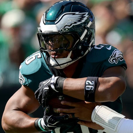 PHILADELPHIA, PENNSYLVANIA - OCTOBER 05: Jalen Hurts #1 hands the ball off to Saquon Barkley #26 of the Philadelphia Eagles during the NFL 2025 game between Denver Broncos and Philadelphia Eagles at Lincoln Financial Field on October 05, 2025 in Philadelphia, Pennsylvania. (Photo by Emilee Chinn/Getty Images)