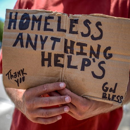 Providence, RI- 07/20/2016- PICTURED IS: A homeless man holds a sign on Point Street and Eddy. Providence Journal / David DelPoio RI_Providence_Journal Providence panhandlers work out issues of turf to collect spare change on highway ramps and intersections.