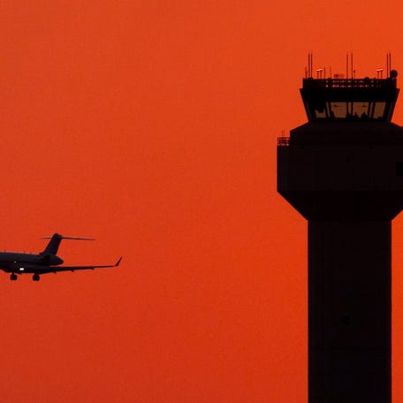 A private jet passes the control tower as it lands at Palm Beach International Airport on Nov. 9, 2025, in West Palm Beach, Florida.