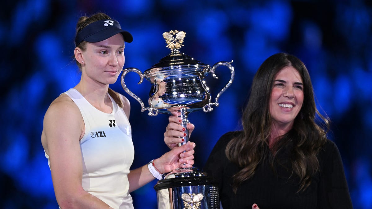 Kazakhstan's Elena Rybakina is presented with the trophy by former tennis player Jennifer Capriati after winning her women's singles final against Belarus' Aryna Sabalenka.