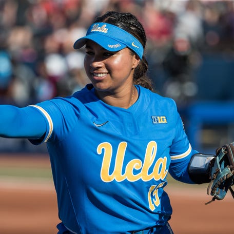 May 31, 2025; Oklahoma City, OK, USA; UCLA Bruins infielder Jordan Woolery (15) reaches out to slap hands with a teammate in the first inning against the Texas Tech Red Raiders during the NCAA Softball Women's College World Series at Devon Park.
