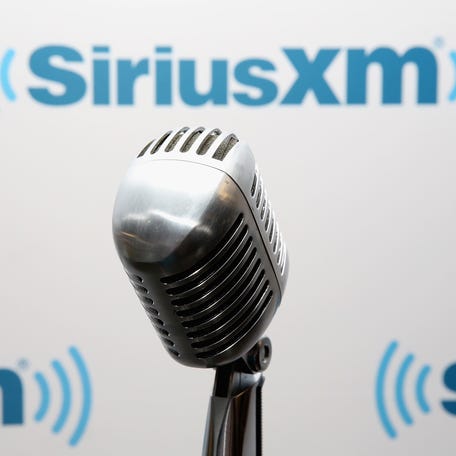 A microphone is pictured in front of a SiriusXM logo.