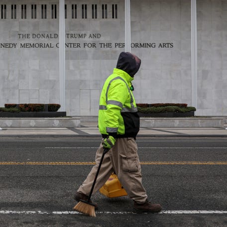 A worker walks in front of the recently renamed Donald J. Trump and John F. Kennedy Memorial Center for the Performing Arts, in Washington, D.C., U.S., December 29, 2025.