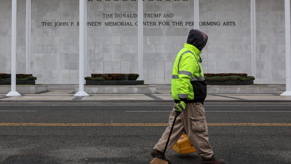 A worker walks in front of the recently renamed Donald J. Trump and John F. Kennedy Memorial Center for the Performing Arts, in Washington, D.C., U.S., December 29, 2025.