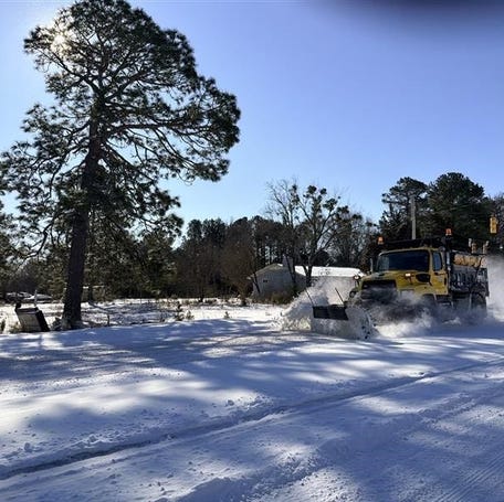 A snow plow clears the road on North Carolina 210 in Spring Lake, North Carolina, on Feb. 1, 2026.