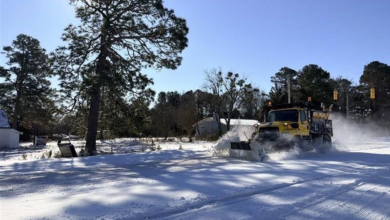 A snow plow clears the road on North Carolina 210 in Spring Lake, North Carolina, on Feb. 1, 2026.
