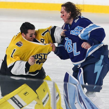 Boston Bruins goaltender Jeremy Swayman (1) and Tampa Bay Lightning goaltender Andrei Vasilevskiy (88) exchange punches as officials Kyle Flemington and Julien Fournier look on during the second period in the 2026 Stadium Series ice hockey game at Raymond James Stadium on Feb. 1, 2026.