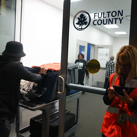 Ballots arrive at the Fulton County Elections Hub and Operation Center on election night on November 5, 2024 in Fairburn, Georgia. Americans cast their ballots that day in the presidential race between Republican nominee former President Donald Trump and Democratic nominee Vice President Kamala Harris.