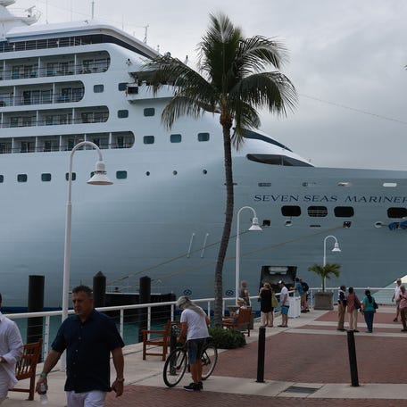 People enjoy Mallory Square as the Regent Seven Seas Mariner cruise ship is docked at the Mallory Square Dock on December 1, 2023 in Key West, Florida.