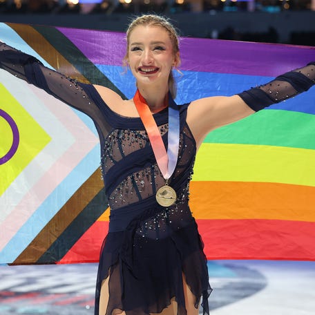 Amber Glenn poses with a Pride flag after the victory ceremony for the 2026 U.S. figure skating championships in St. Louis on Jan. 9, 2026.